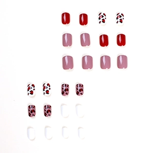 Glossy leopard print press-on nails in vibrant red and pink tones on white background