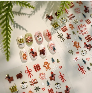 Detailed Christmas nail decals with gingerbread man, dachshund, and holiday bows