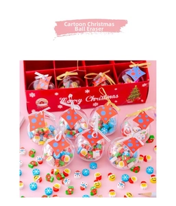 Close-up of Christmas themed crystal ball erasers set in a red gift box display
