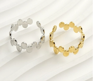 Detail of adjustable geometric disc rings in polished gold and silver stainless steel