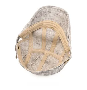 Detail of the grey washed fabric texture and khaki inner sweatband of the newsboy hat