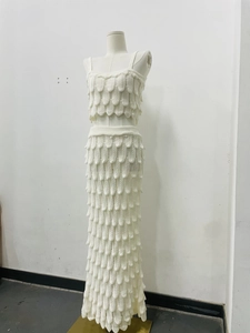 Detailed view of white knit two-piece set featuring a unique 3D scale textured design