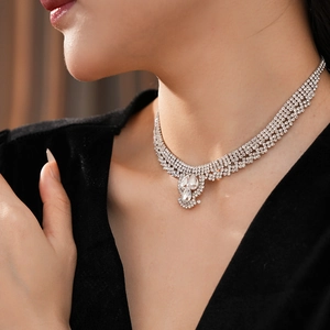 Close-up of layered silver water-drop necklace with rhinestones on a model