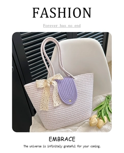Detail of lavender woven tote bag with beige lace bow and golden rivets on the flap