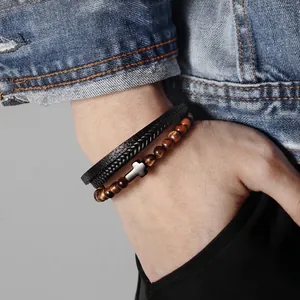 Men's multi-layer bracelet set with black leather, woven cords, and tiger eye stone beads