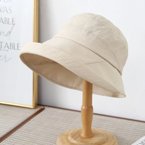Beige wide brim sun hat for women with minimalist breathable fabric and parallel stitching
