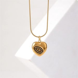 Gold heart pendant necklace with black oval texture on a sleek snake chain