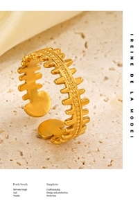 Macro shot of gold fishbone ring detailing the 18K gold plated texture and adjustable opening