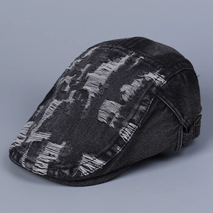 Close-up of distressed black denim ivy cap showing frayed holes and metal buckle