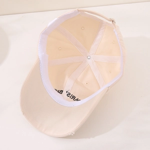 Interior detail of beige cotton baseball cap with sweatband and Paris embroidery
