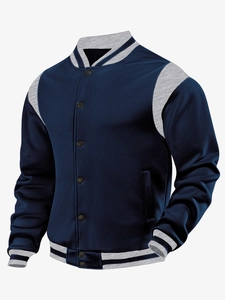 Detail of navy blue varsity jacket featuring light gray sleeves and striped ribbed trims