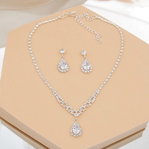 Detailed view of silver bridal jewelry set with sparkling teardrop crystal pendants
