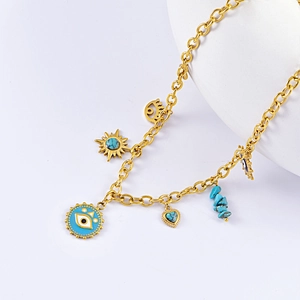 Detailed view of bohemian gold alloy necklace with blue evil eye and sun charms