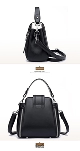 Side and back view of a minimalist black crossbody bag with silver zippers and strap