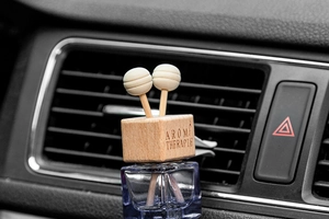 Car air vent glass perfume bottle with blue liquid, wooden cap and aroma sticks