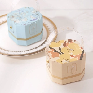 Elegant octagonal floral wedding candy boxes in blue and cream with clear handles