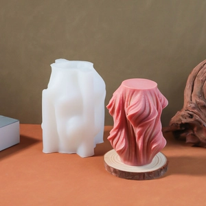 Detailed view of spiral column silicone mold and finished textured geometric candle
