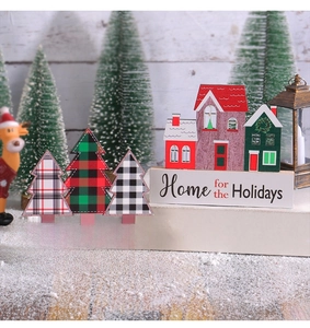 Detailed view of festive wooden house and plaid Christmas tree table decorations
