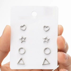 Detailed view of four pairs of stainless steel stud earrings in heart and star shapes