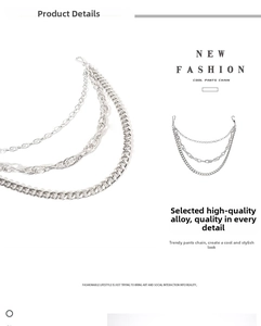 Detail of multi-layered silver alloy pant chains with large lobster clasps and street style