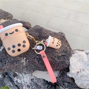 Close-up of pearl milk tea silicone case with pink lanyard on natural rock background