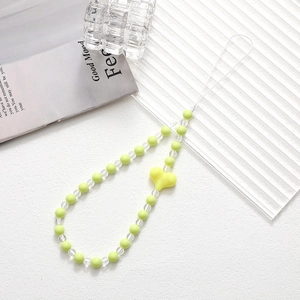Detail of beaded phone strap with green beads and a bright yellow heart charm decoration