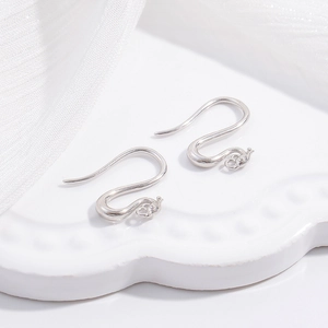 Detailed view of silver S925 C-shaped ear hooks with vintage phoenix eye relief texture