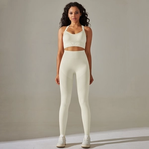 Detailed texture of seamless knit off-white yoga set with high waist and ribbed waistband