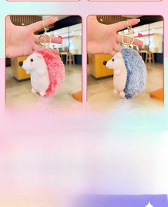 Detail view of plush hedgehog keychains in red and blue with gold metal ring hooks