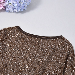 Detailed view of bronze sequins on a knit mesh top with a stylish crew neckline