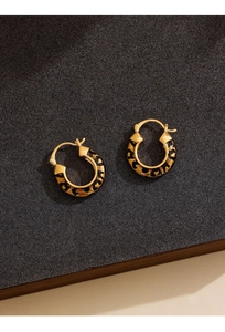 Macro view of 14k gold plated round hoop earrings with retro leopard print enamel pattern