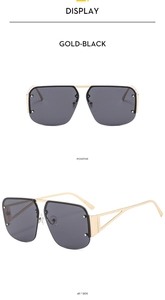 Detail view of gold-black metal semi-rimless sunglasses with hollow geometric temple design