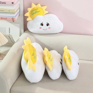 Detailed view of white cloud plush pillow set with sun accents on a cozy beige sofa