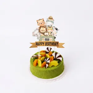 Close-up of jungle animal cake topper with Happy Birthday banner for kids party