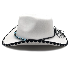 Detail of cream western cowboy hat with black braided edge and turquoise bead accents