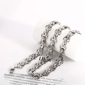 Macro detail of steel color Byzantine chain necklace with lobster clasp and industrial texture