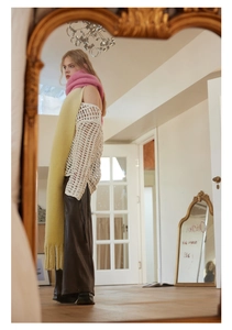 Artistic reflection of a yellow and pink gradient knitted scarf with a white hollow knit top