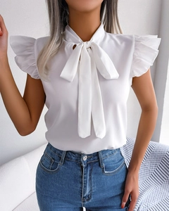 Detail of white sleeveless chiffon shirt with bow tie neckline and layered ruffles