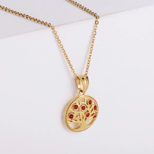 Macro view of 18k gold plated Tree of Life pendant necklace with red rhinestones