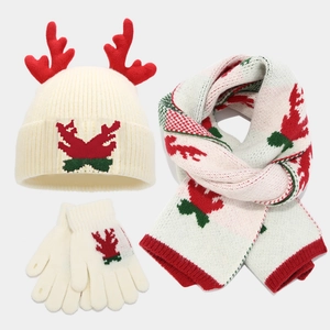Detailed view of knitted Christmas antler hat, scarf, and gloves set in cream and red