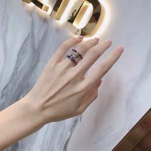 Detail of a wide S925 silver ring featuring vibrant colorful zircon stones on a hand
