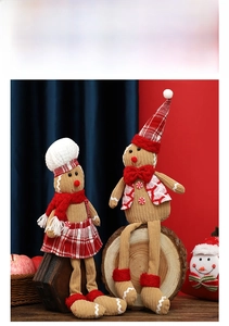 Close-up of sitting gingerbread man plush dolls with long legs and corduroy texture