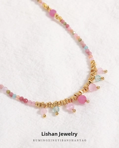 Detailed close-up of Bohemian beaded necklace with natural stones and golden spacers