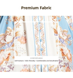 Detail of floral chiffon fabric with matching blue buttons on a long-sleeve print dress