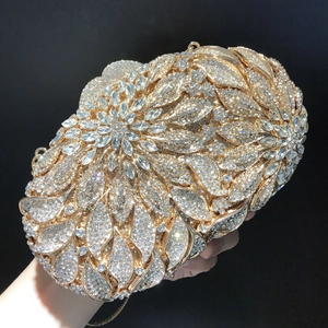 Macro detail of luxury evening clutch bag with leaf patterns and sparkling rhinestones
