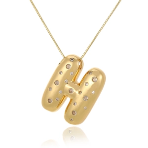 Close-up of golden letter H pendant set with small diamonds on a fine chain