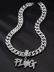 Close-up of iced out PLUG pendant on silver Cuban link chain with luxury crystal details