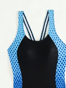 Detail of high-stretch racing swimsuit featuring blue scale patterns and black panels
