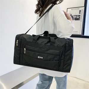 Close-up of durable black nylon travel bag with shoulder strap and S SPORT logo detail