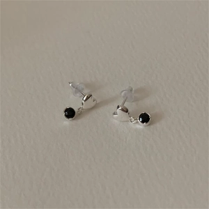 Detail of 925 sterling silver heart earrings with hanging black zircon stones